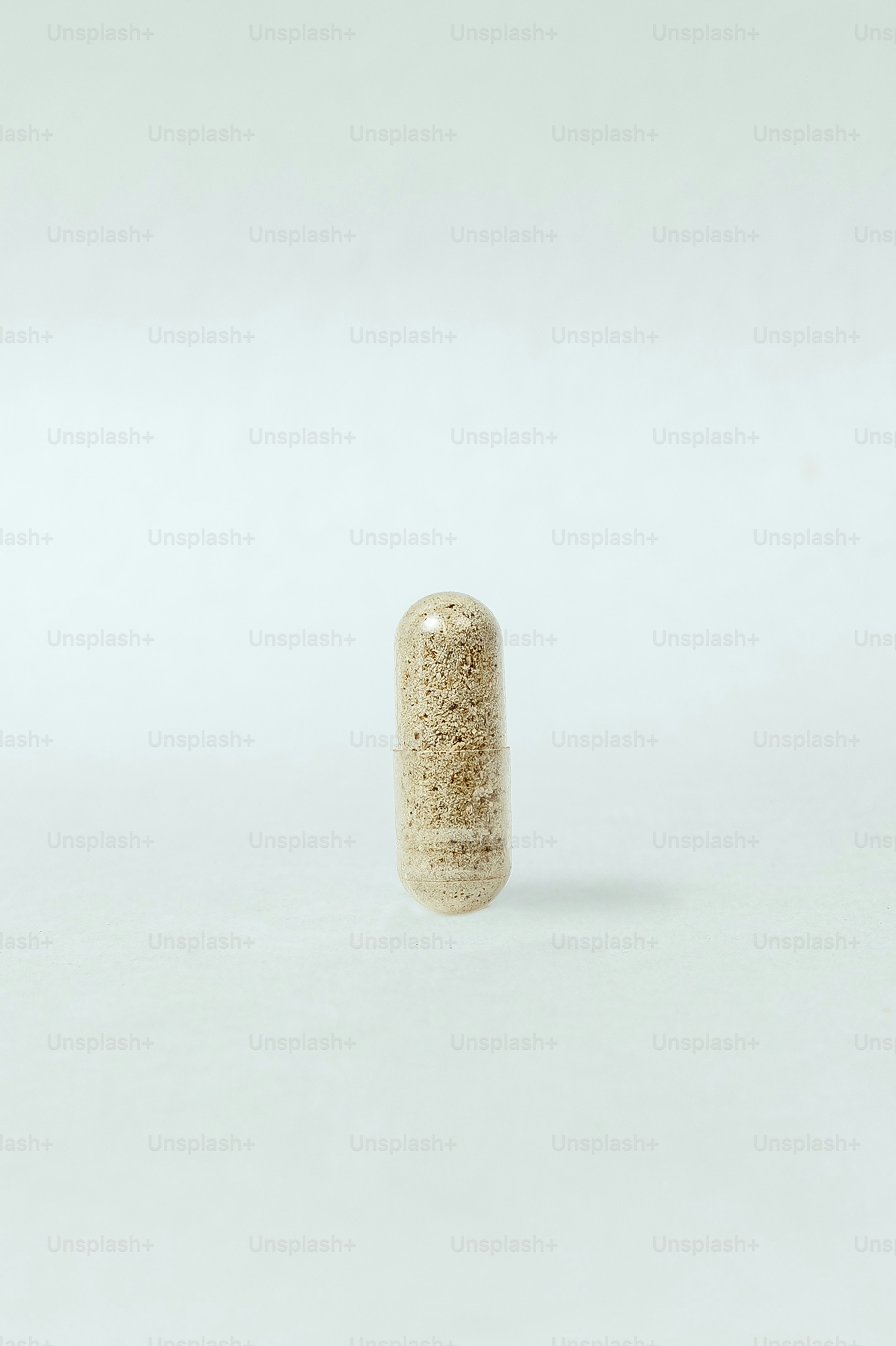 a small white object sitting on top of a white surface